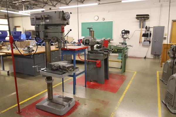 Another view of what looks like drilling machines--three different types of machine. One is green in color and appears older.