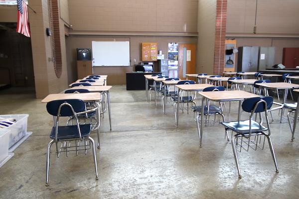 Rows of desks and a marker board inside the auto shop