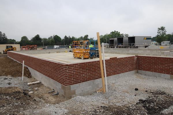 A view from the side of the incomplete greenhouse. The bricks look new and fresh.. very nice.