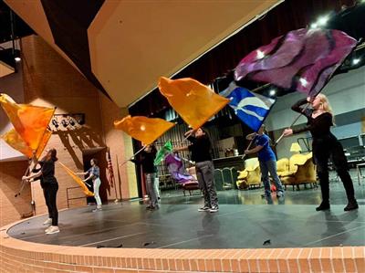 Members of the color guard perform in the TCSC auditorium--on stage!